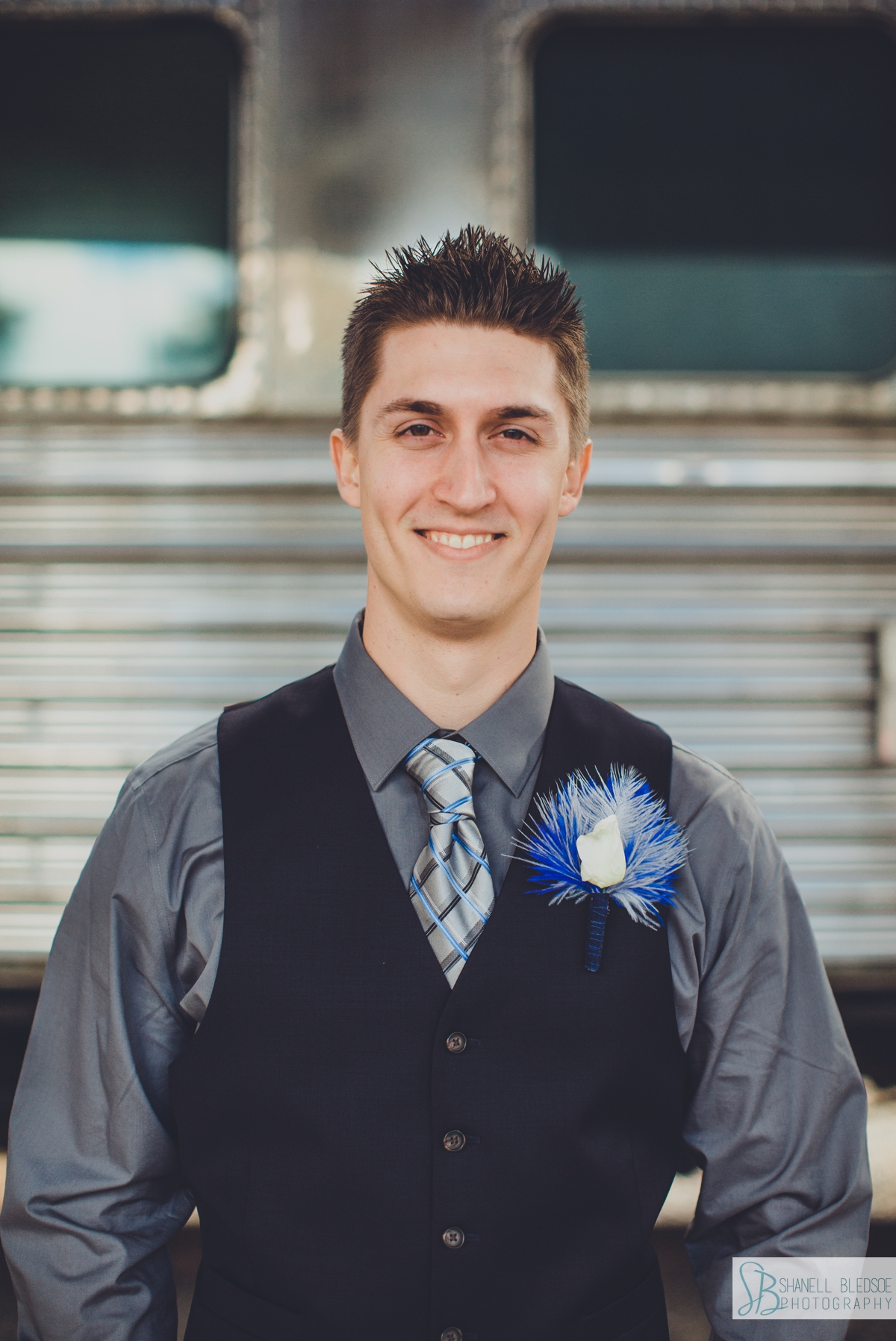 Groom portrait in front of train car at historic southern railway station in knoxville