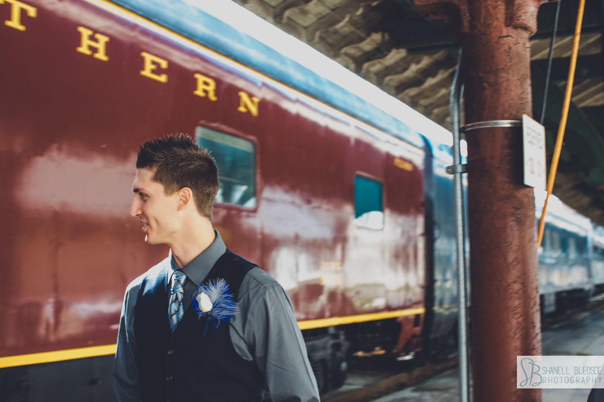 Groom in front of train car at historic southern railway station in knoxville