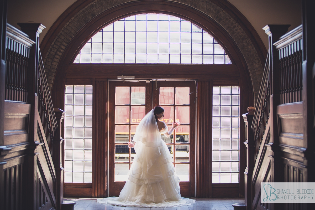 bride in front of grand entrance arched windows at historic southern railway station