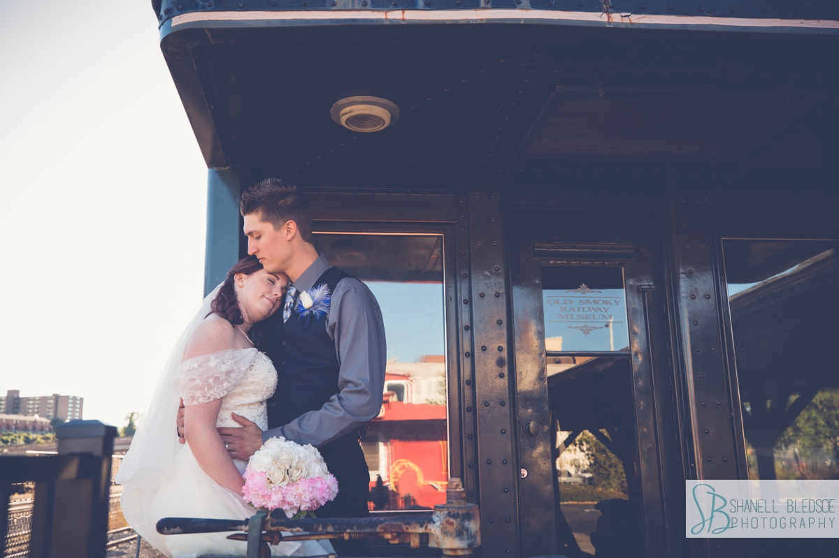 bride and groom on train at historic southern railway station in knoxville wedding photos