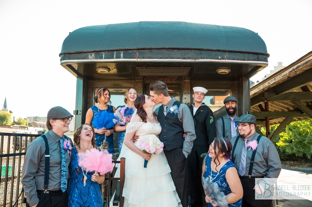 roaring 20s wedding party on train car at historic southern railway station