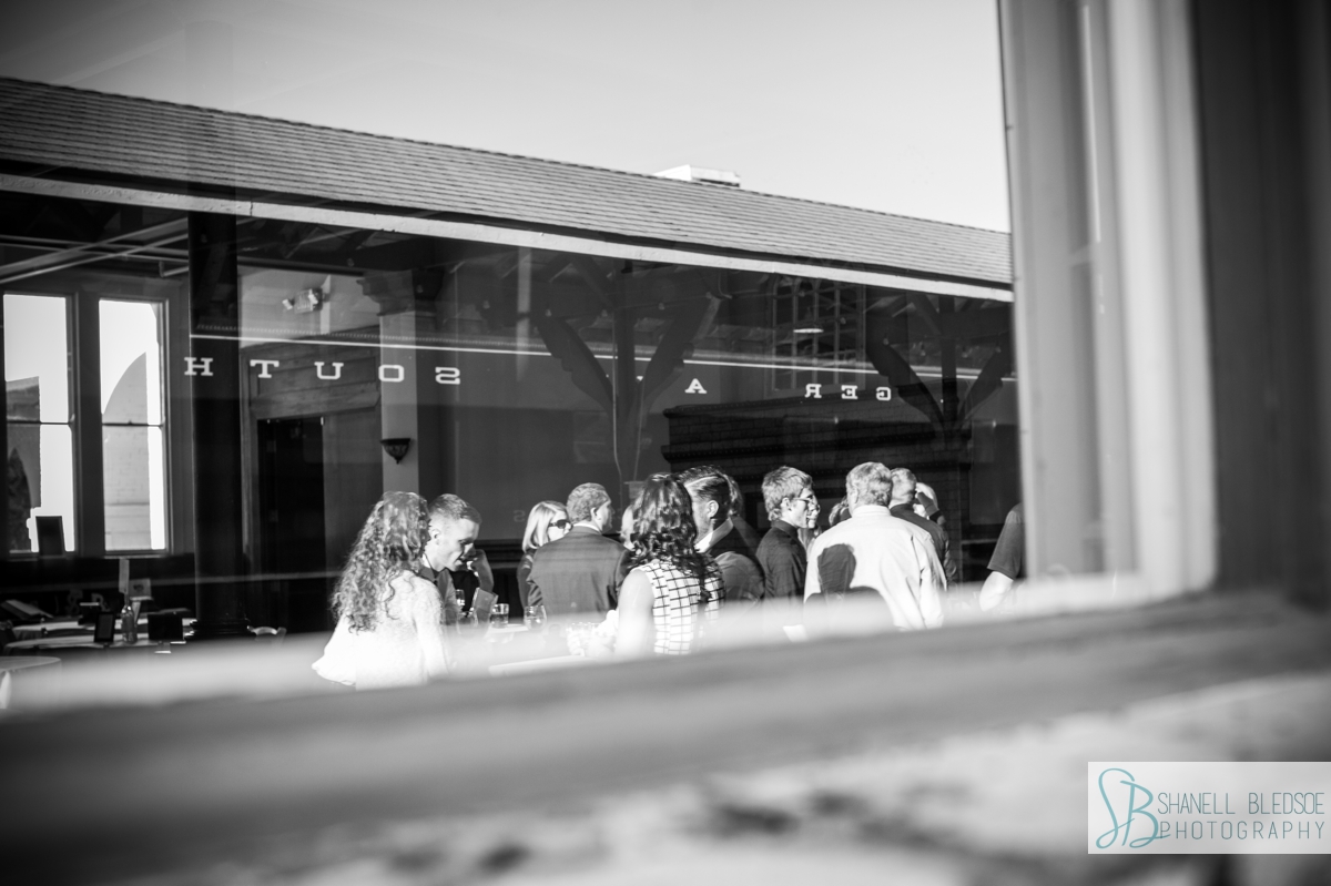 guests and train reflection at cocktail hour wedding at historic southern railway station