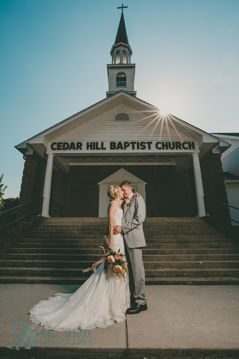bride and groom in front of southern traditional church wedding sunbeam