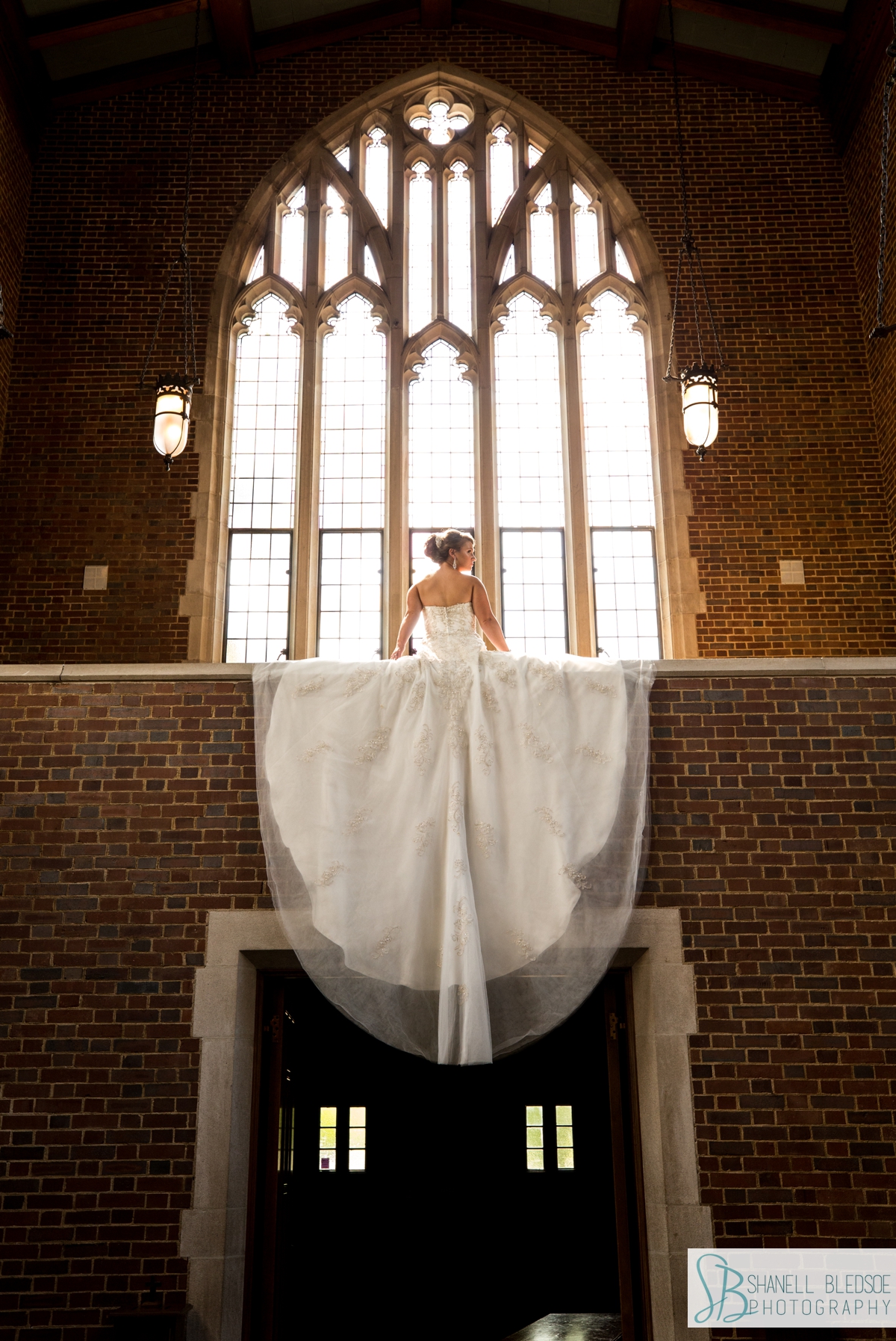 bride in sanctuary of Wightman Chapel's stained glass Gothic arch windows nashville