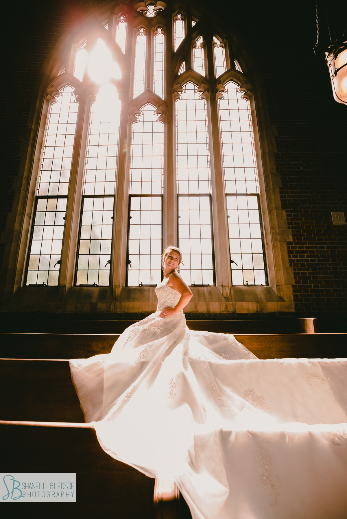 bride in sanctuary of Wightman Chapel's stained glass Gothic arch windows nashville