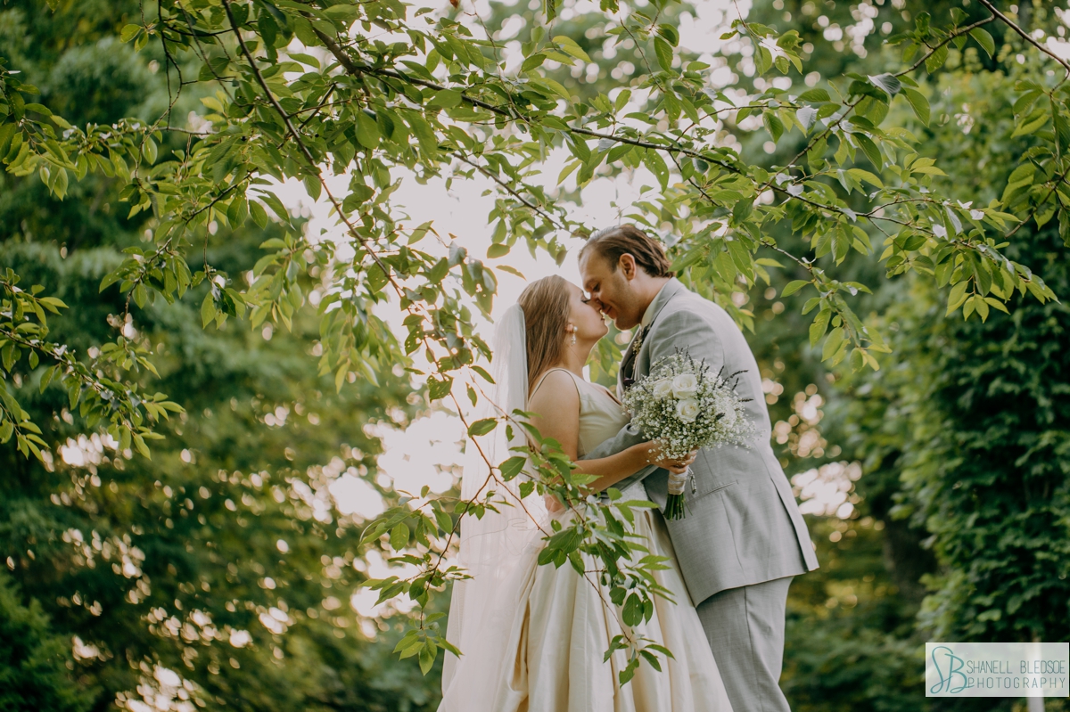 bride and groom in the trees at Rock City portrait 