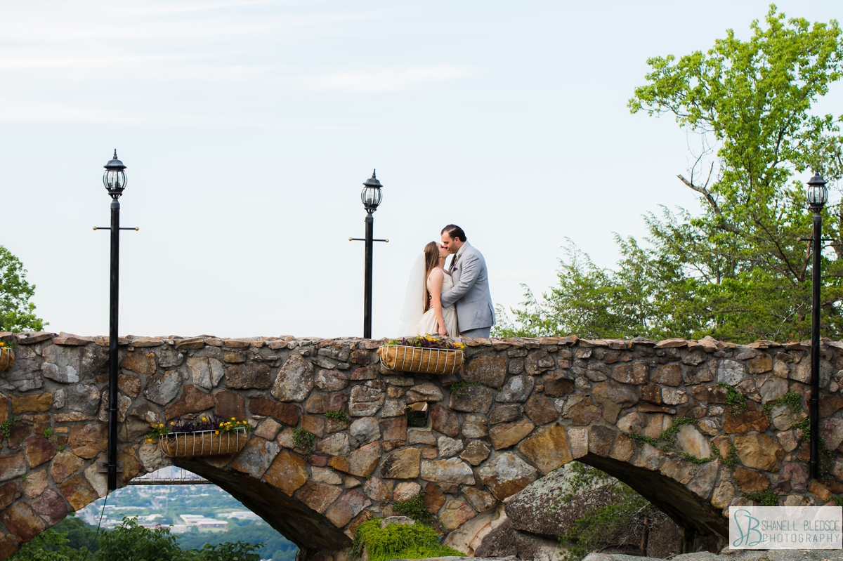 bride and groom on stone bridge at Rock City portrait 
