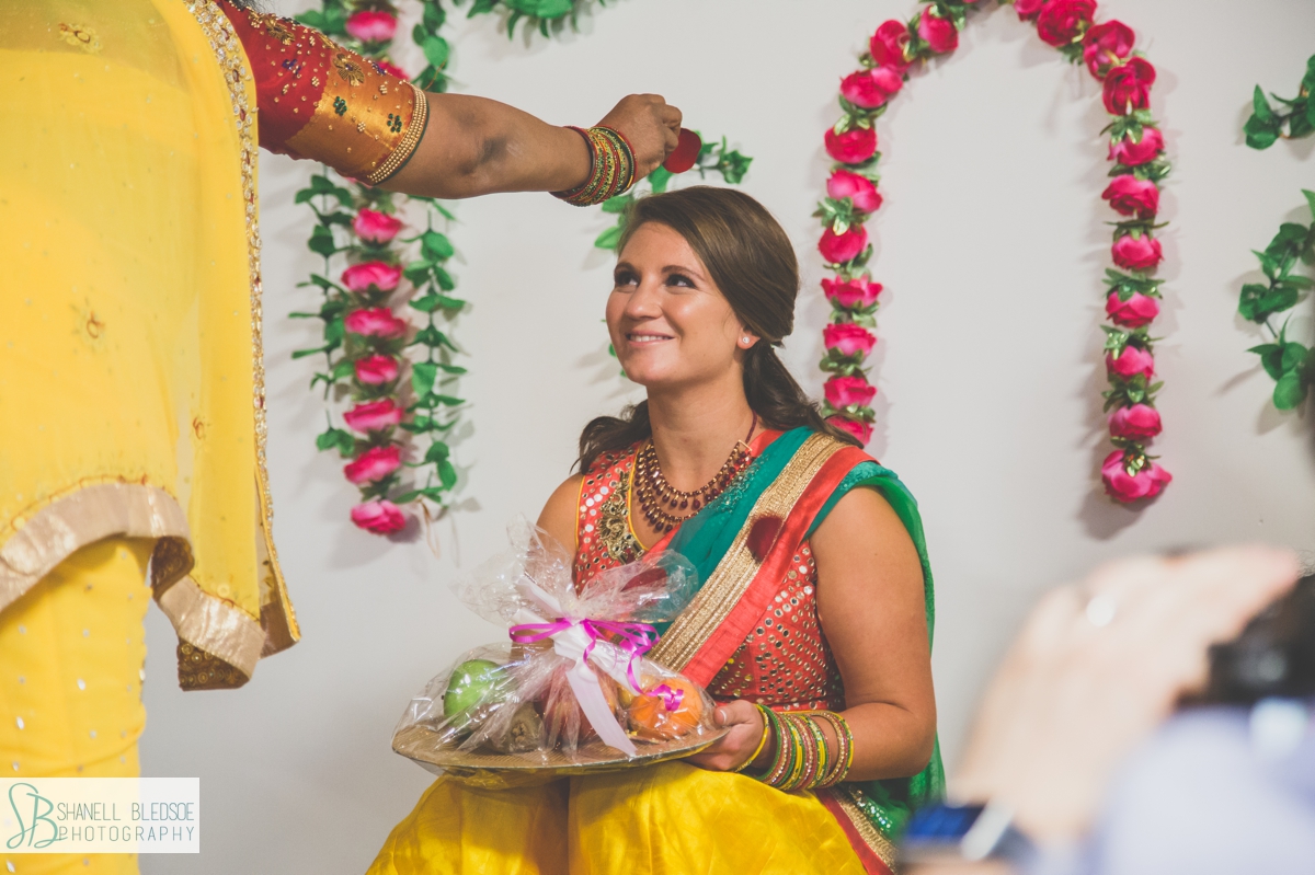 Indian American bride at haldi rose petal blessing