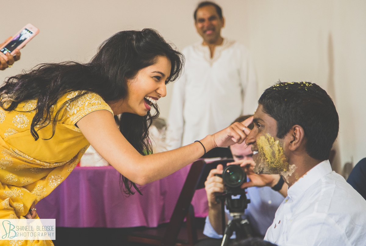 Applying haldi turmeric pithi to groom's face in nashville