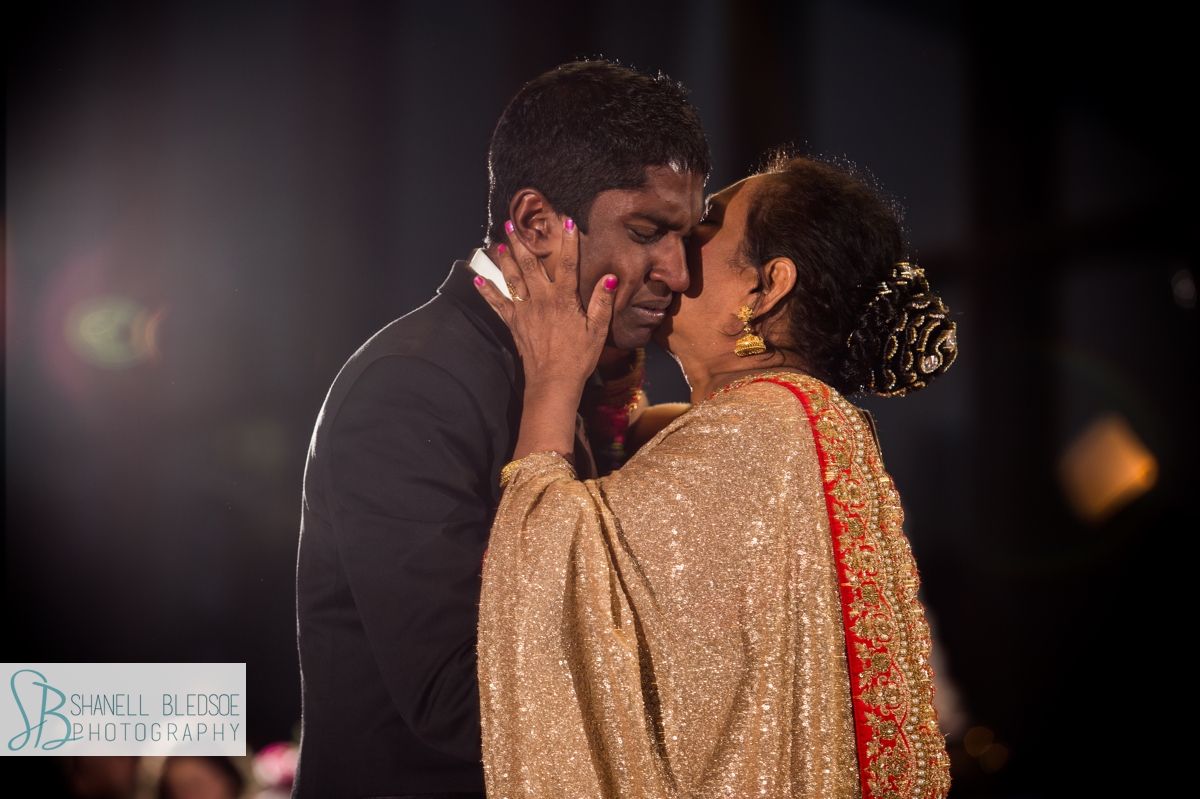 Indian mother kisses son during dance at Indian wedding reception in Nashville