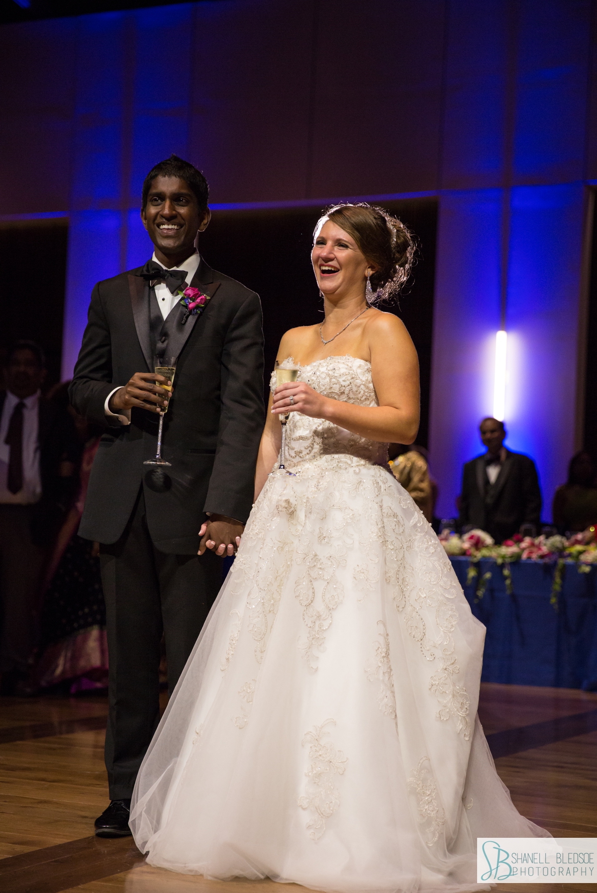 Indian-American wedding reception bride and groom laughing at toast at country music hall of fame