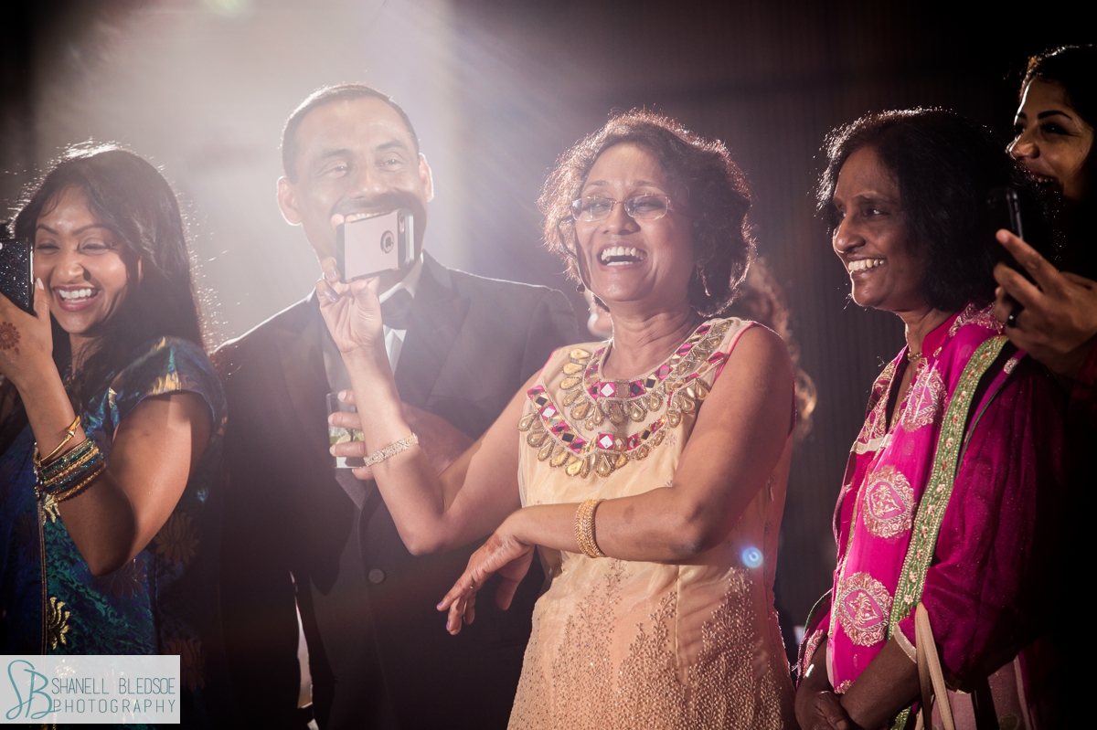 guests laugh at toasts to bride and groom at country music hall of fame Indian wedding reception
