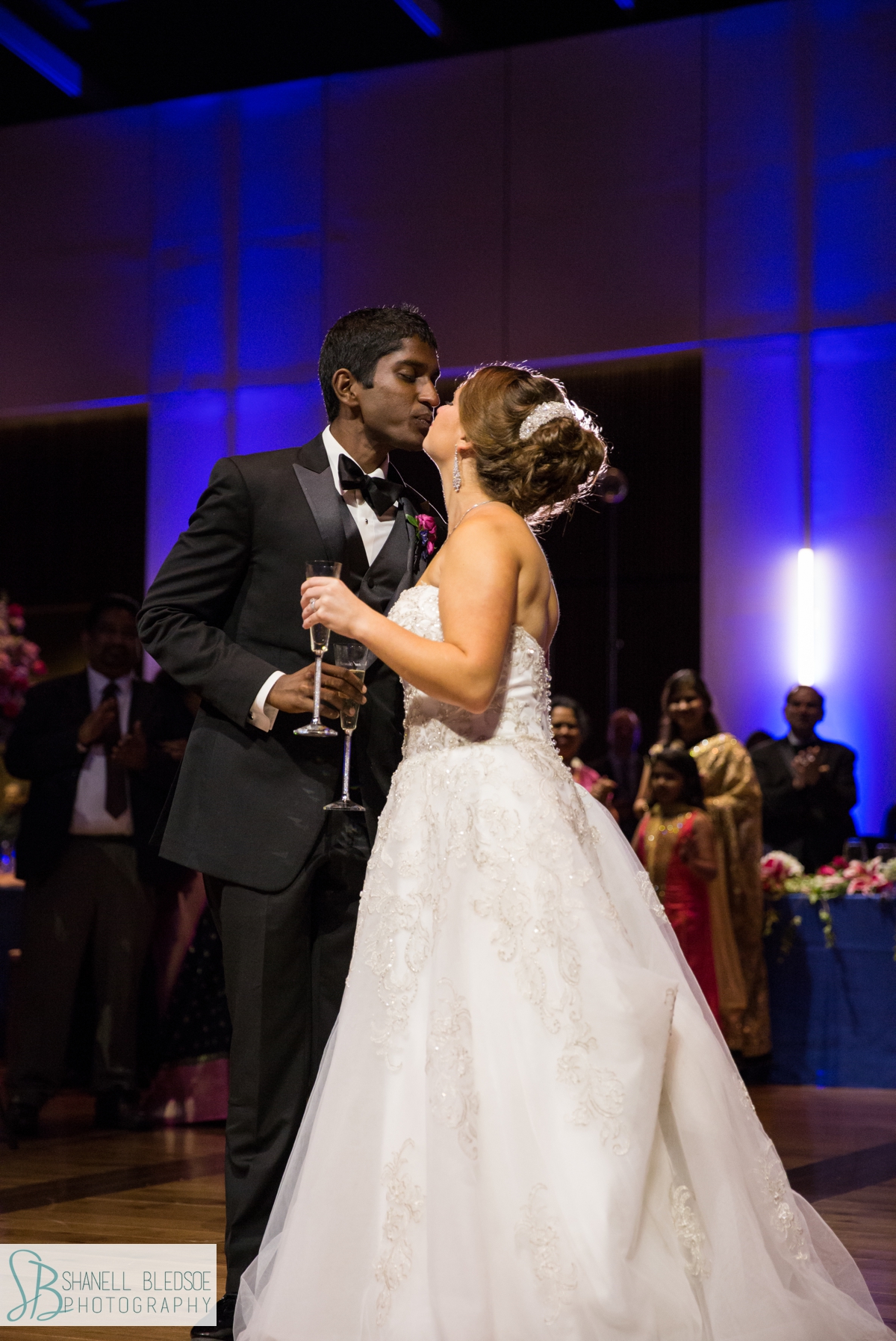 Indian-American wedding reception bride and groom kiss at country music hall of fame