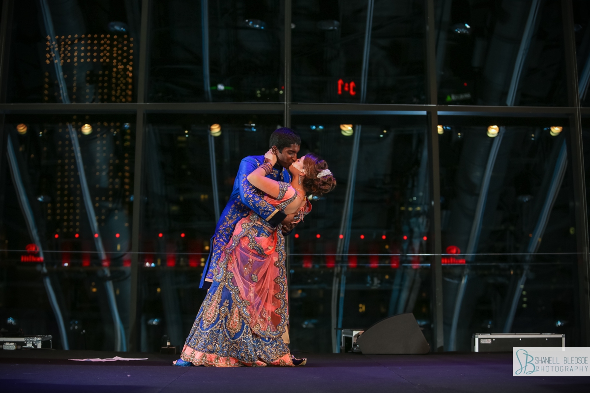 Bride and groom dance in traditional sari sherwani at country music hall of fame