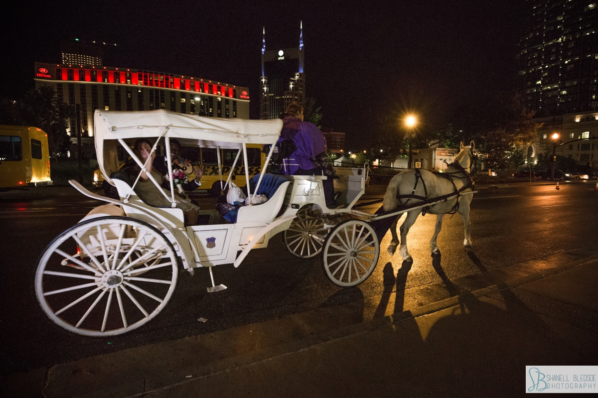 bride and groom leave country music hall of fame on horse and carriage