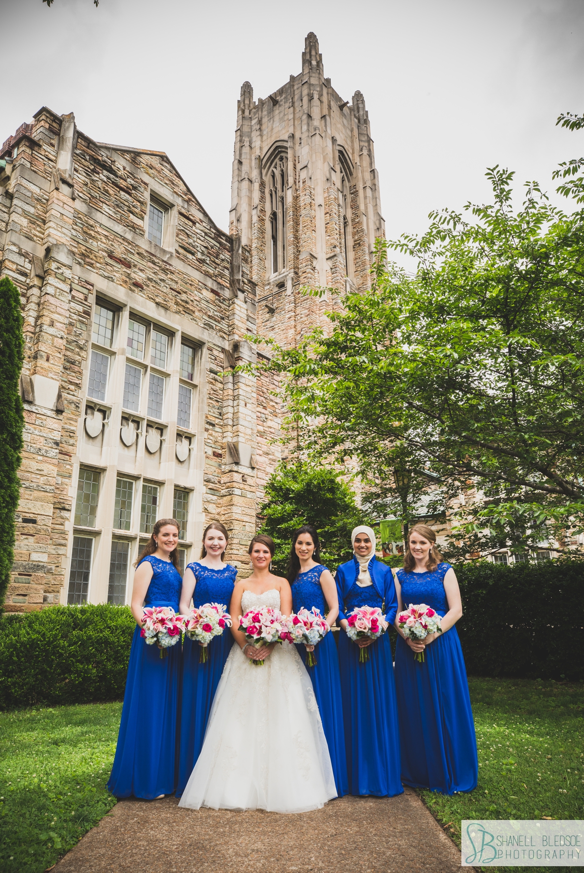 bride with bridesmaids in royal blue lace dresses outside Scarritt Bennett Center wedding
