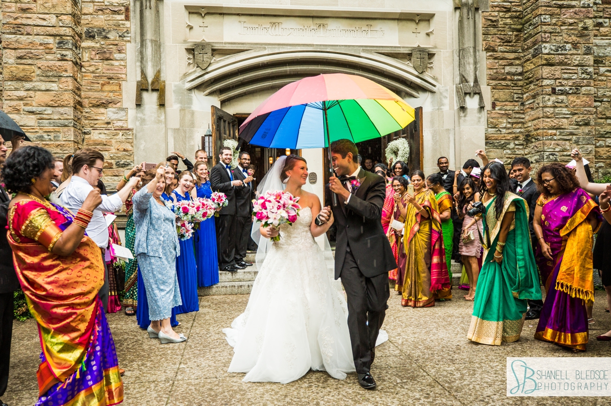Indian groom and American bride leave in rain scarritt bennett wedding nashville photographer