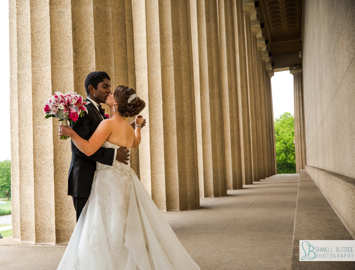 bride and grooms dancing in the columns at the parthenon in nashville
