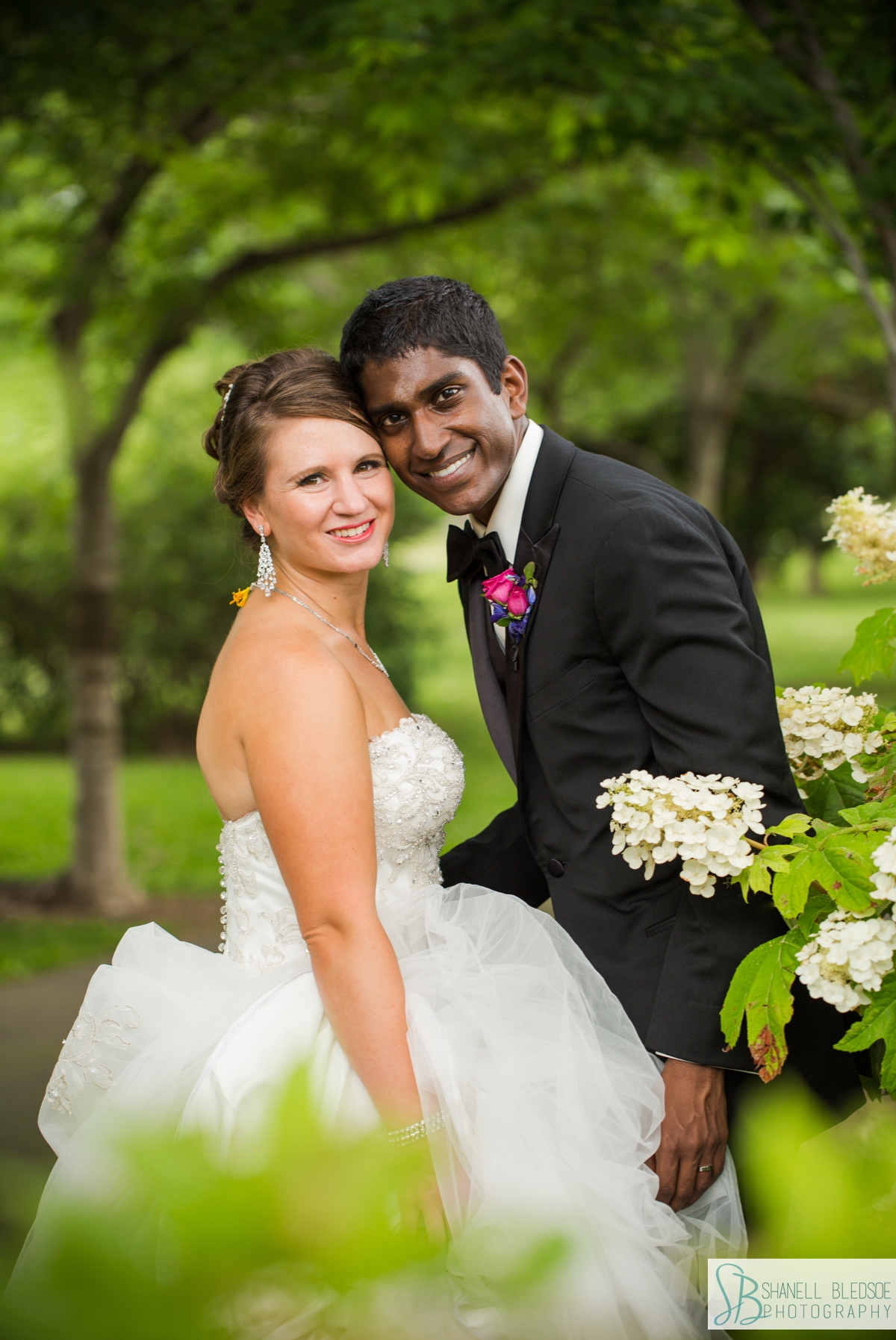 Indian groom and American Bride in garden at Centennial Park in Nashville