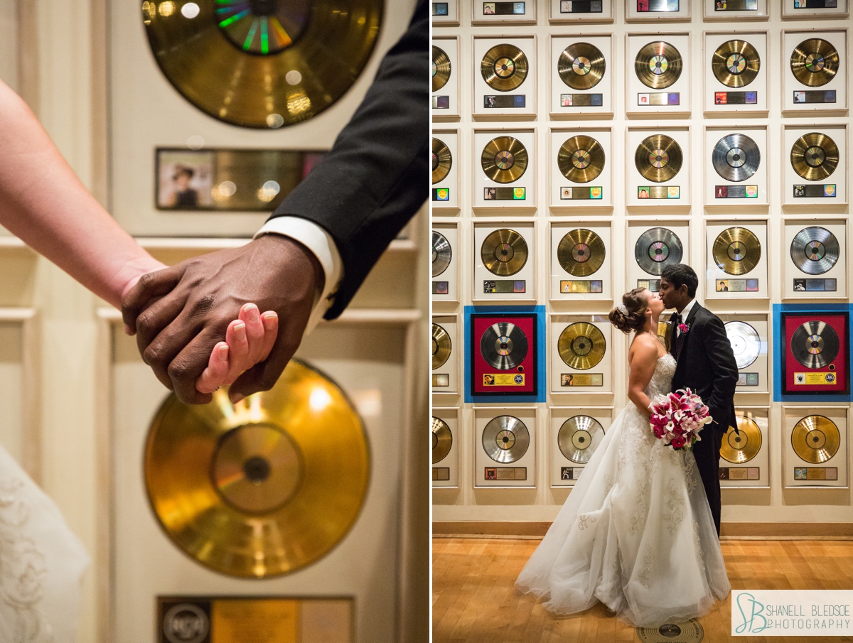 bride and groom in front of the wall of gold records at Country Music Hall of Fame