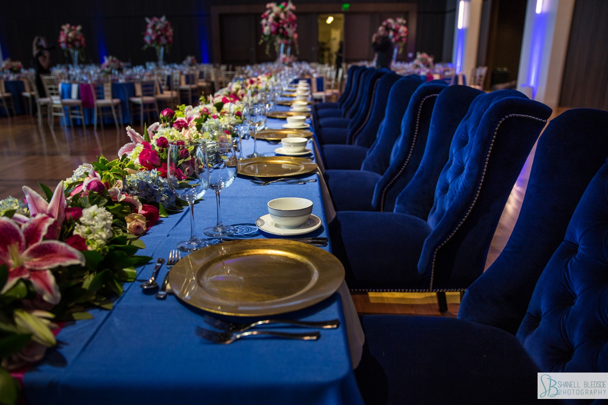 royal blue linens gold chargers and pink stargazer lily on head table wedding reception photo of Event Hall at Country Music Hall of Fame