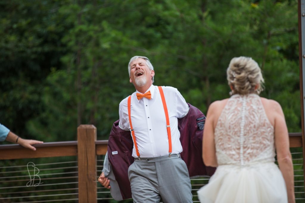 groom dancing at outdoor summer reception