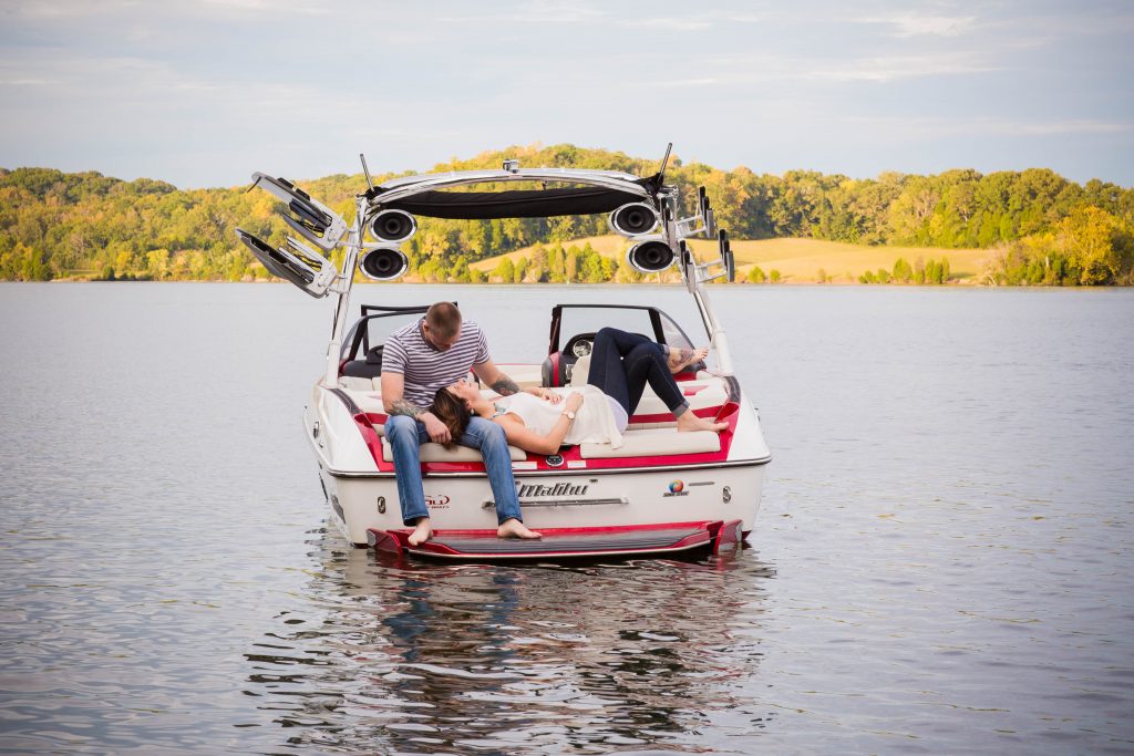 engaged couple on a wakeboard boat in Knoxville