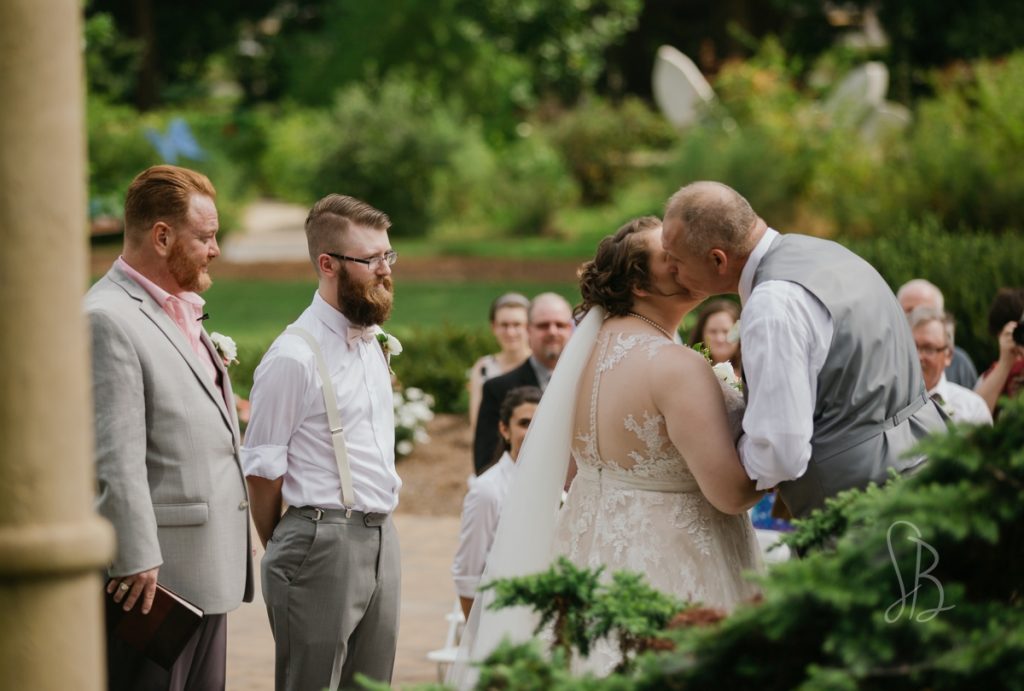 father kissing bride at UT Gardens wedding 