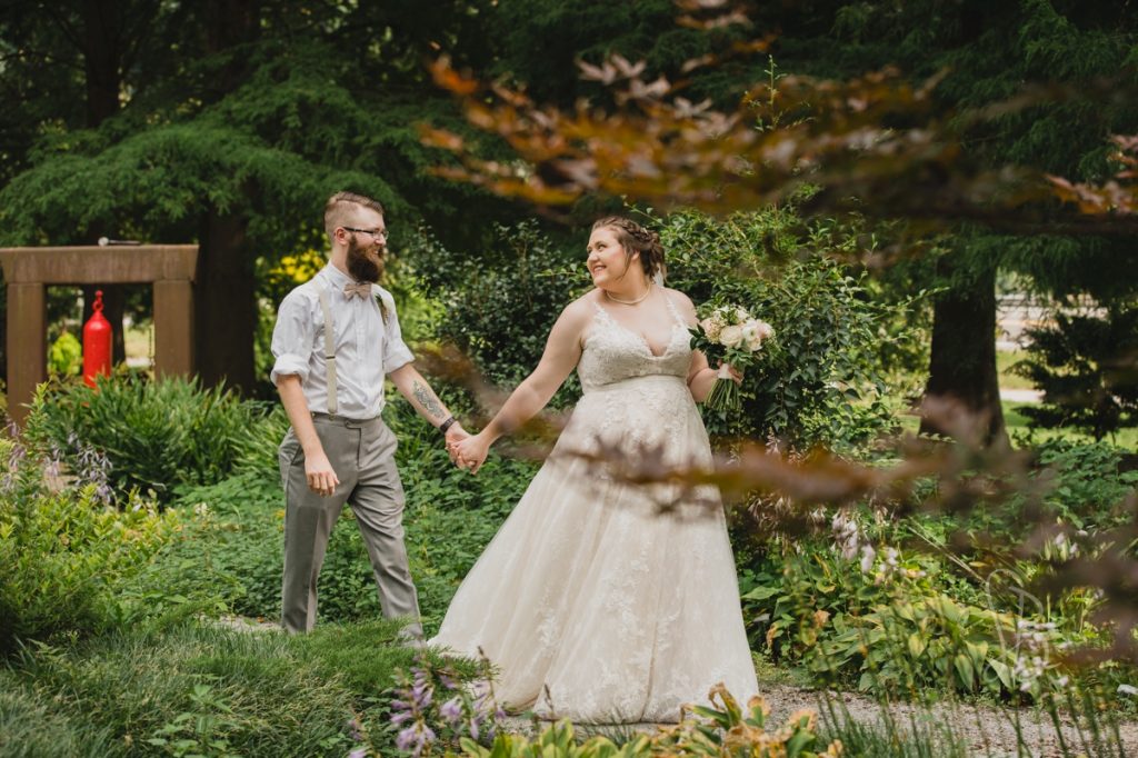 bride and groom walking in Tranquility hosta garden at UT Gardens wedding in Knoxville