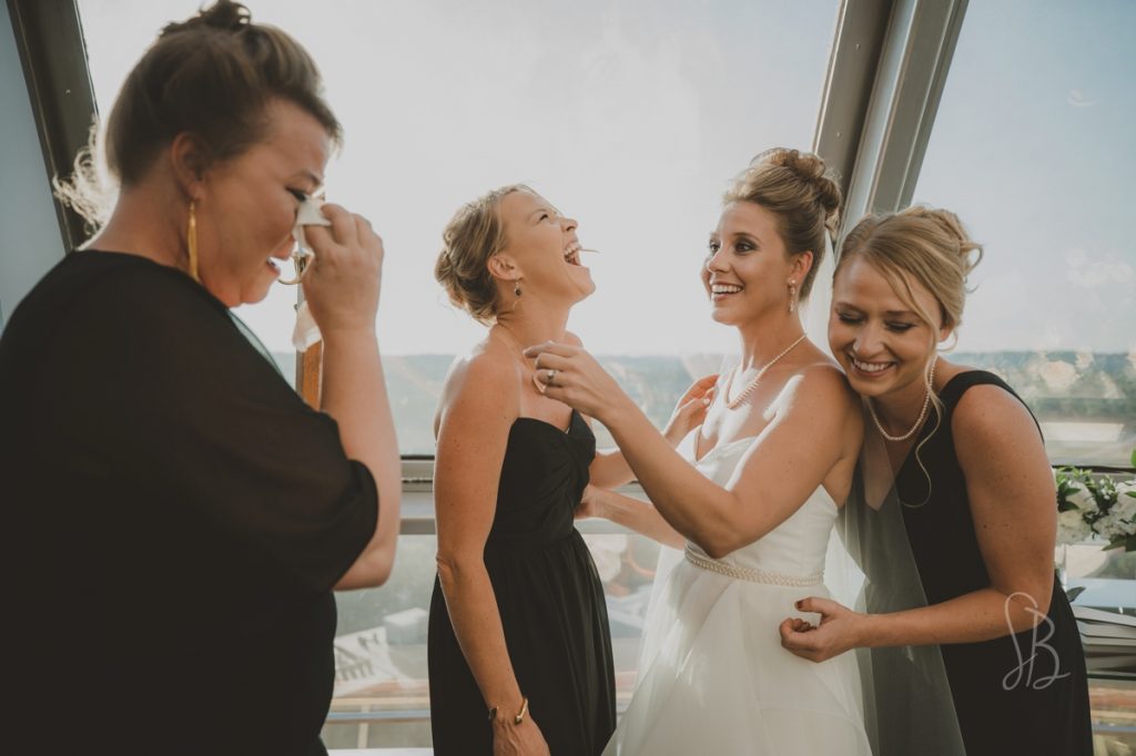 sisters helping bride get ready at Sunsphere knoxville wedding