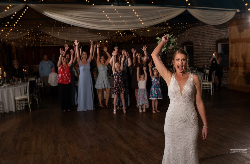 Bride tossing bouquet at The Foundry in Knoxville reception