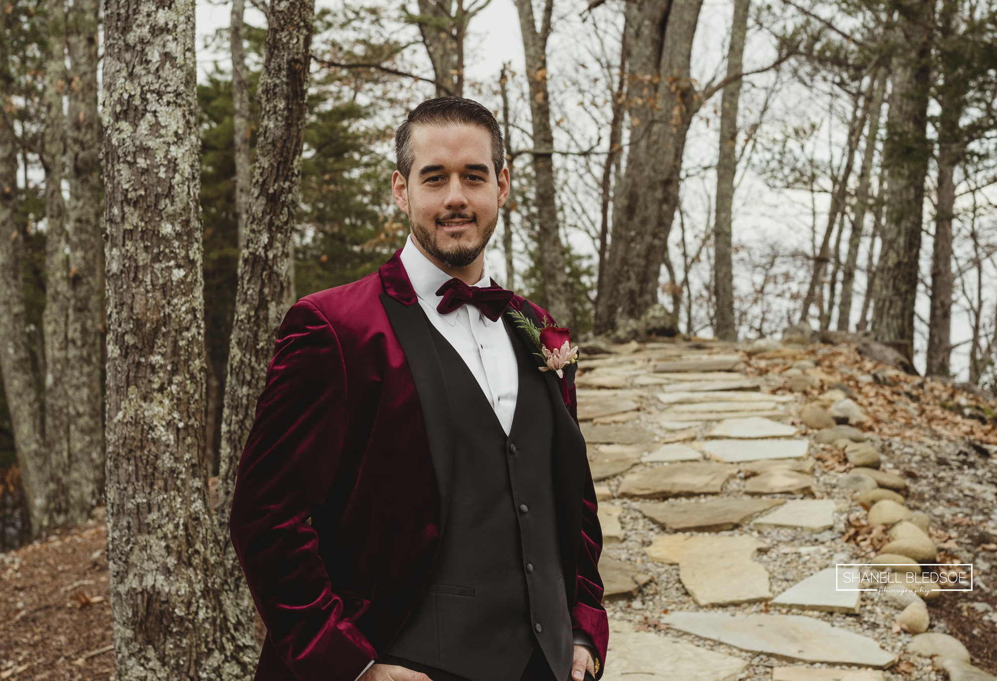 groom in red velvet tux