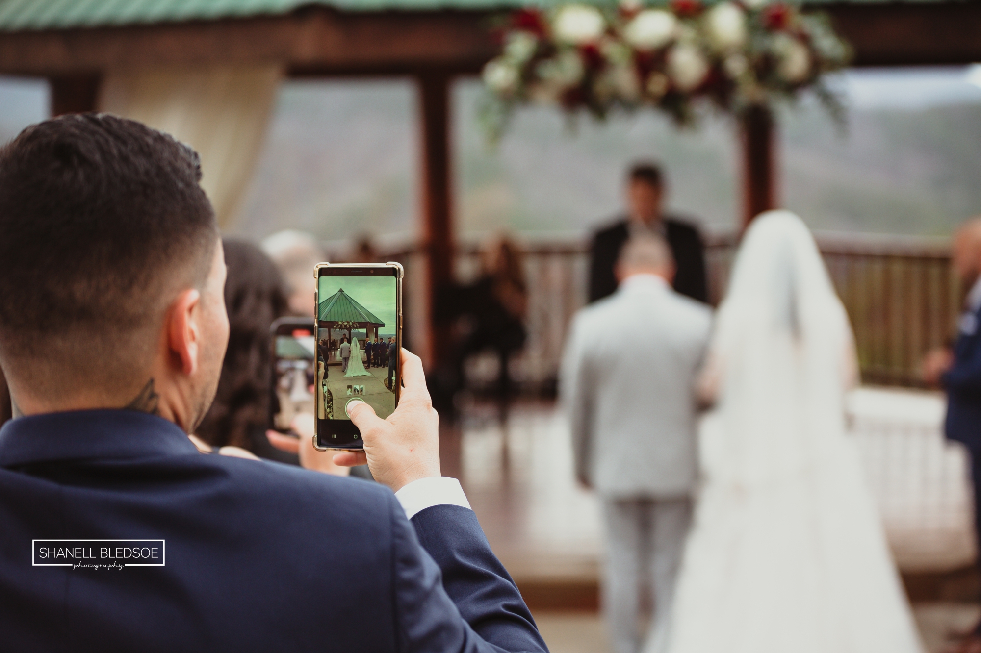 guests using phone during wedding