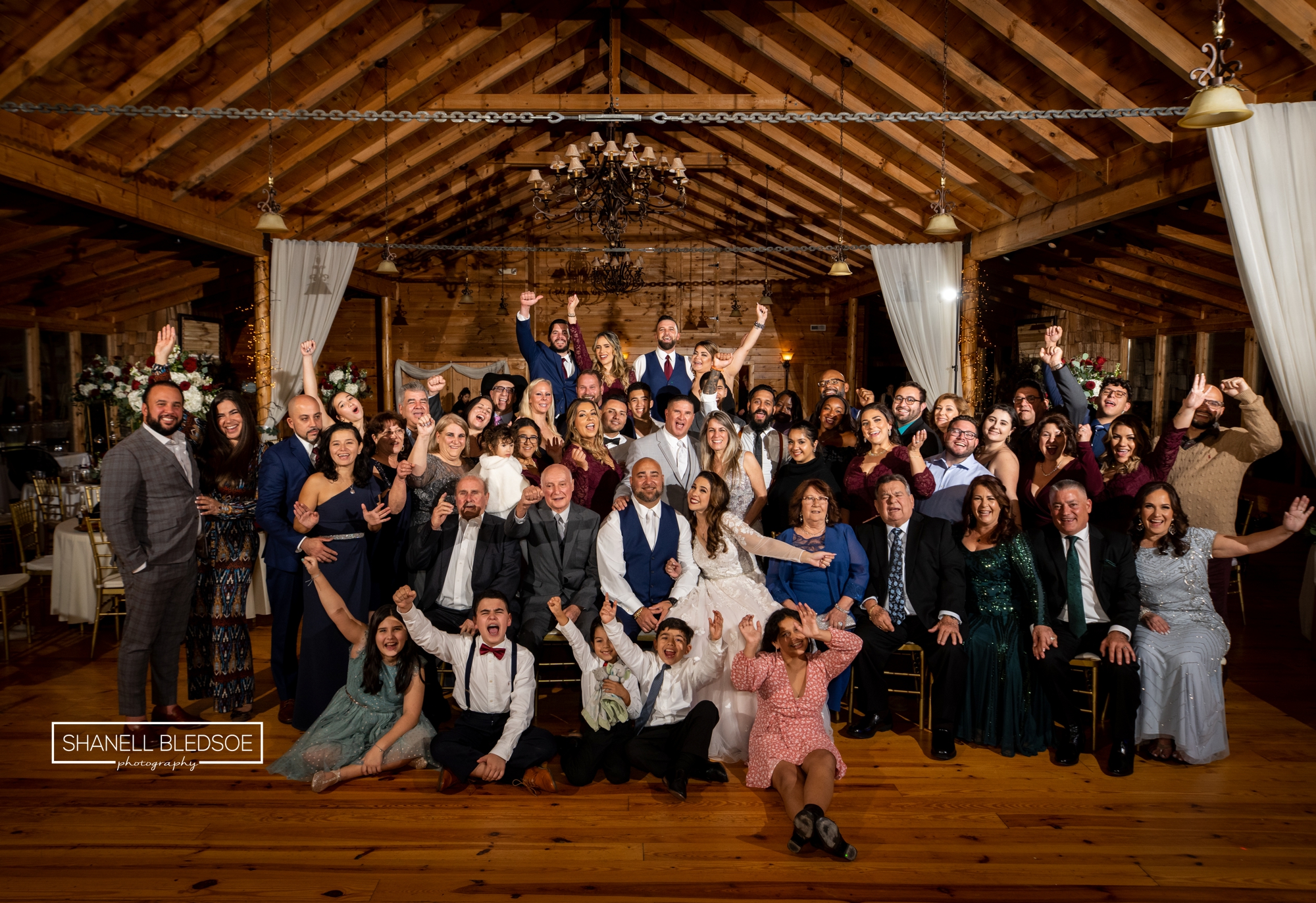 group photo of all wedding guests on dancefloor