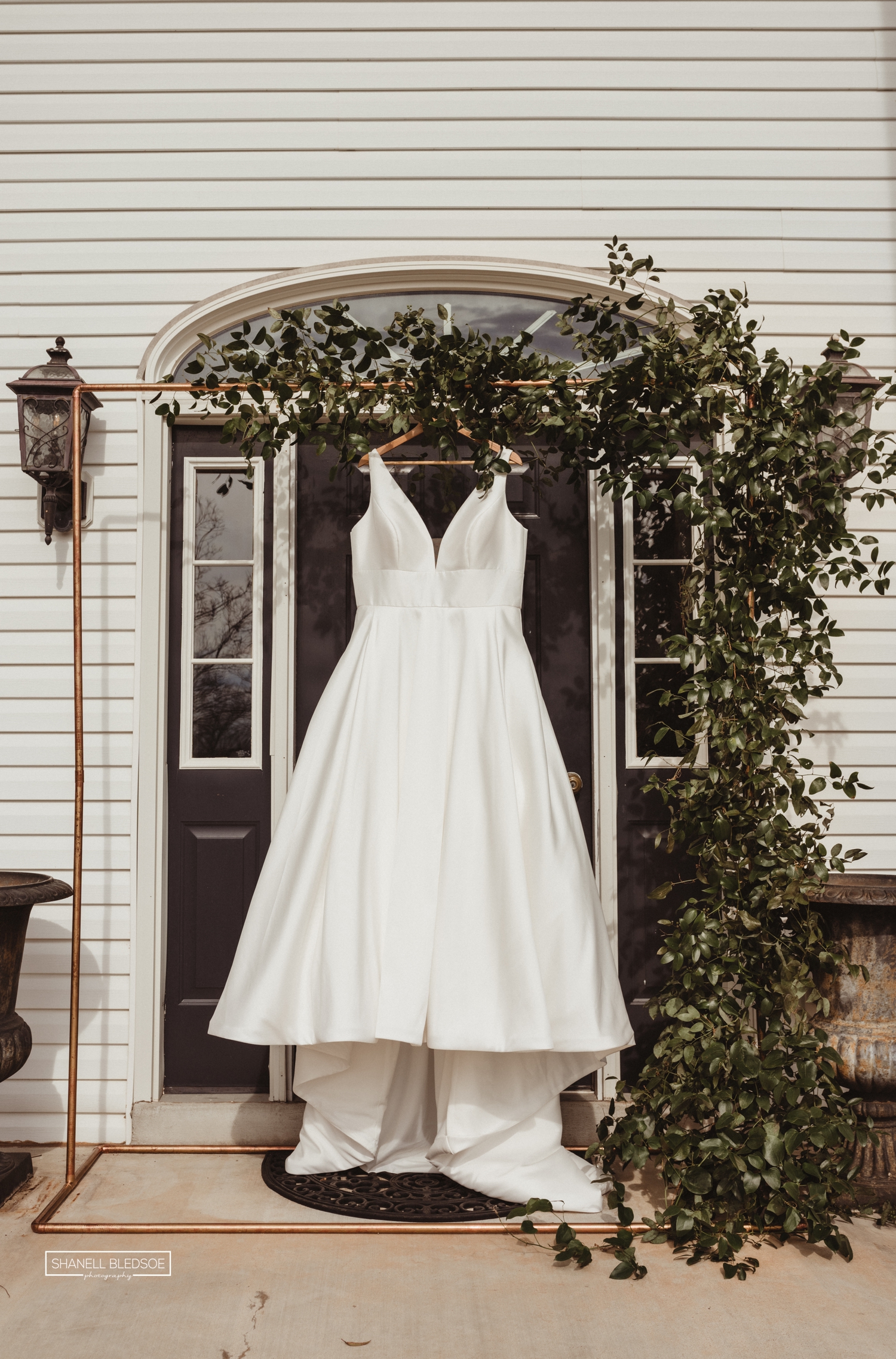 wedding dress hanging from door of Harvest House at Lost Creek Winery