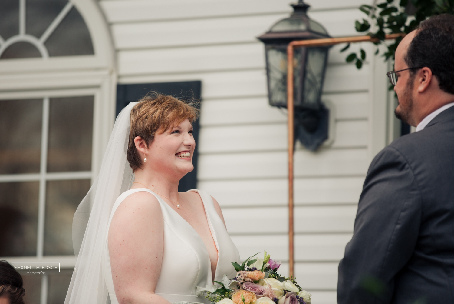 wedding ceremony on veranda of Harvest House at Lost Creek winery