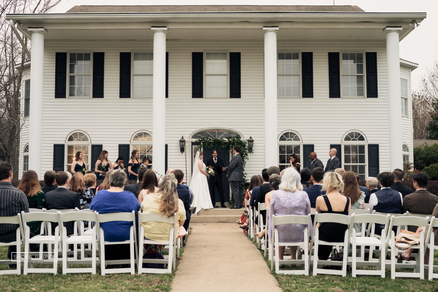 wedding ceremony on veranda of Harvest House at Lost Creek winery