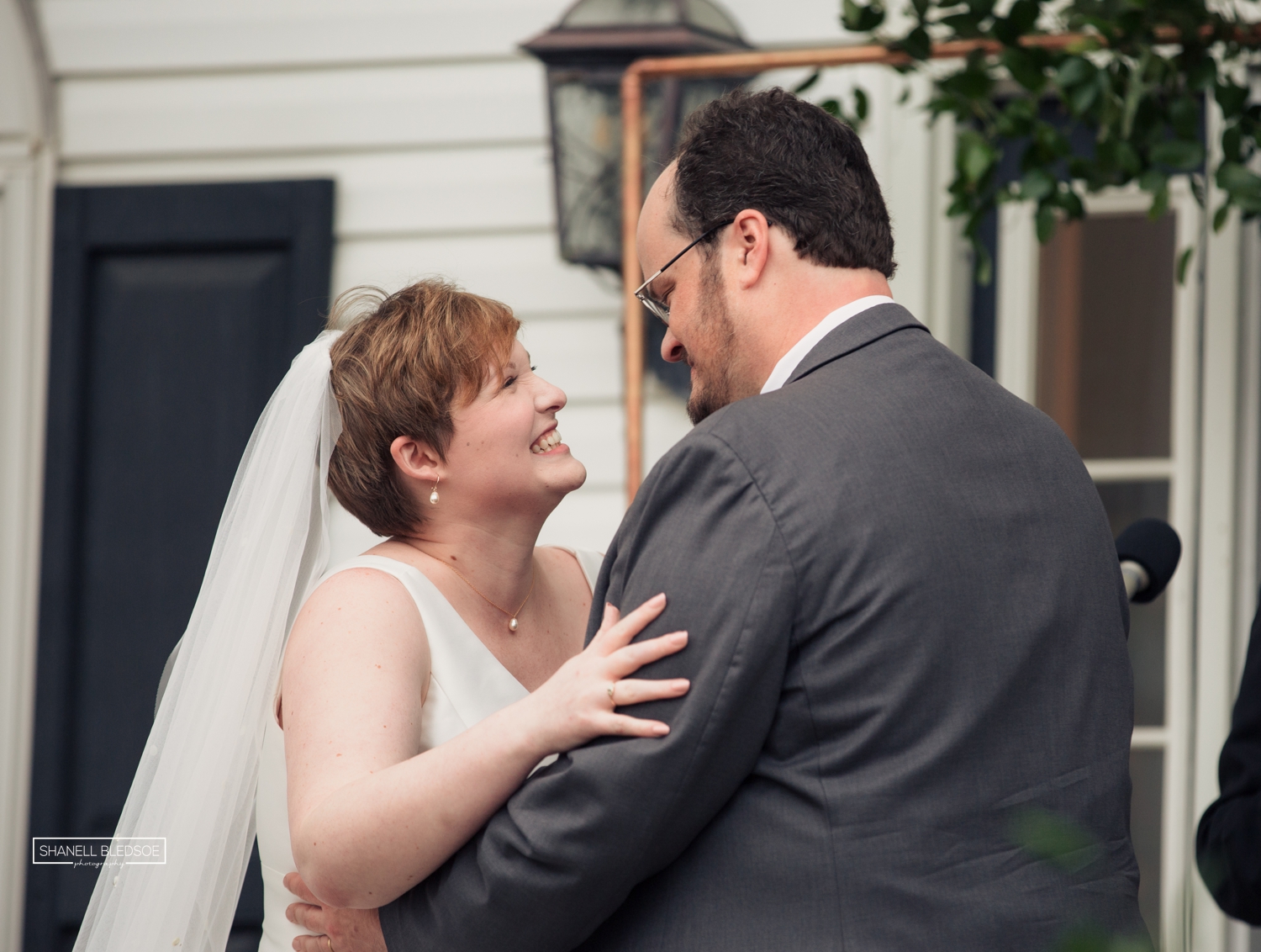 wedding ceremony on veranda of Harvest House at Lost Creek winery