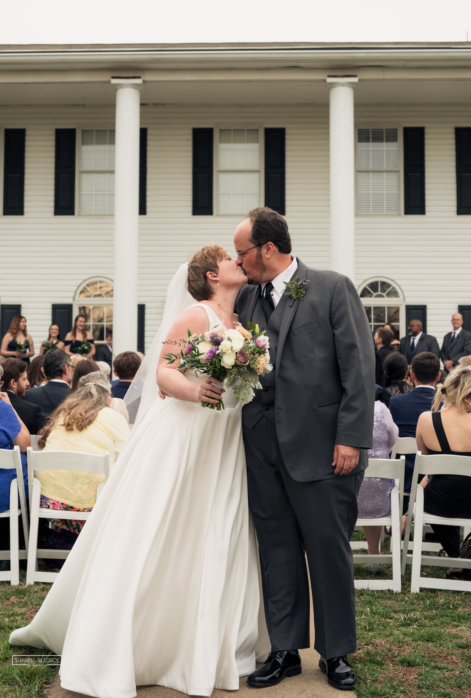 wedding ceremony on veranda of Harvest House at Lost Creek winery