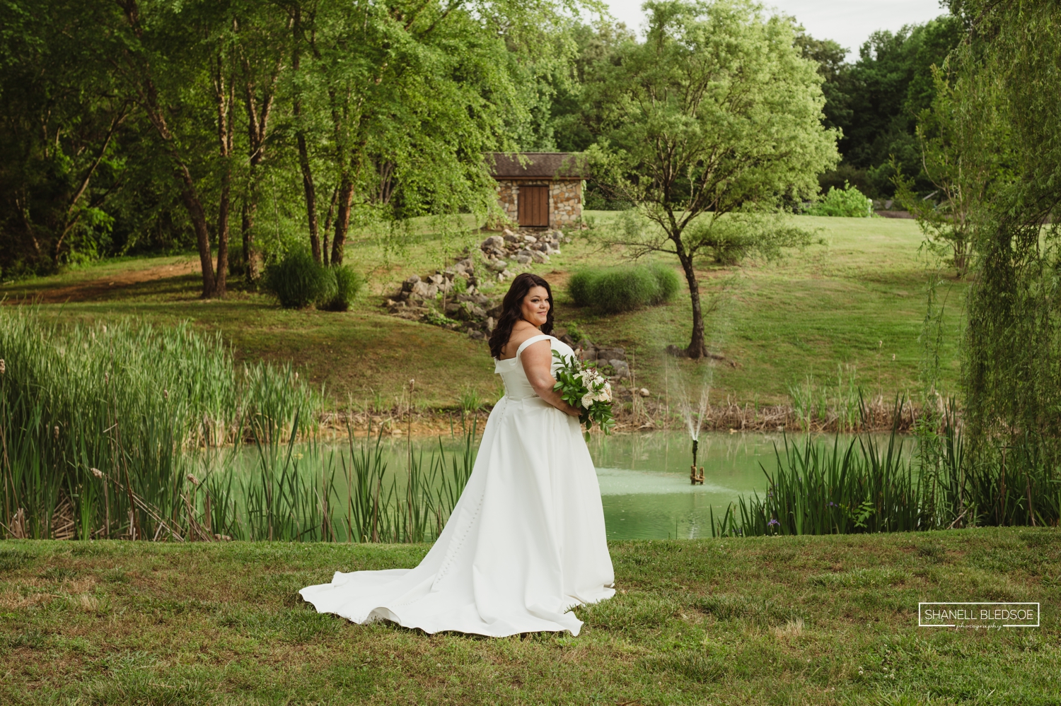 Bride posing at Willow Pond at Willow Ridge Event Center