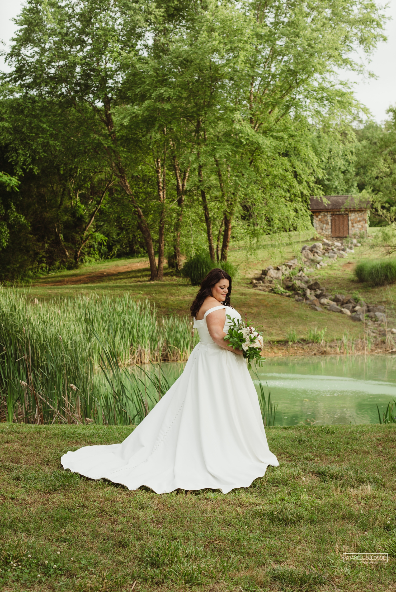 Bride in front of Willow Pond at Willow Ridge Event Center
